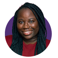 A young adult with long braided hair and a warm smile